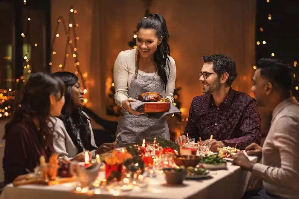 Someone serving Christmas dinner to friends