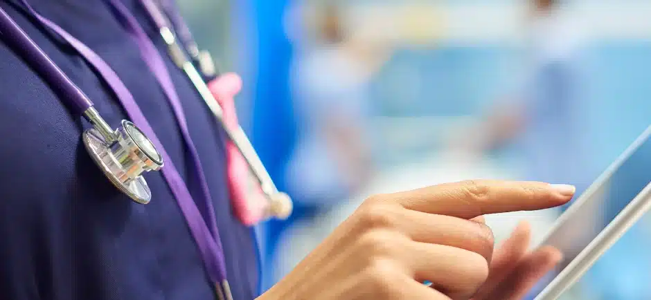 Nurse filling in a form on a tablet