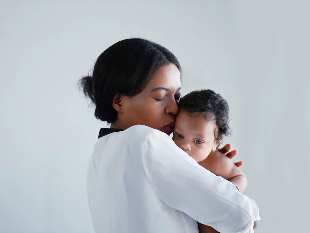 Woman kissing baby
