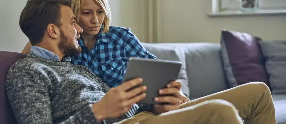 Couple reviewing information on a tablet
