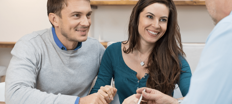 Happy couple talking to doctor