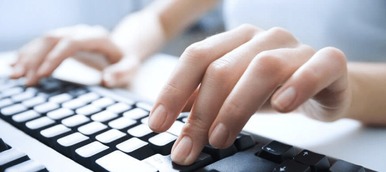 Hands typing on keyboard