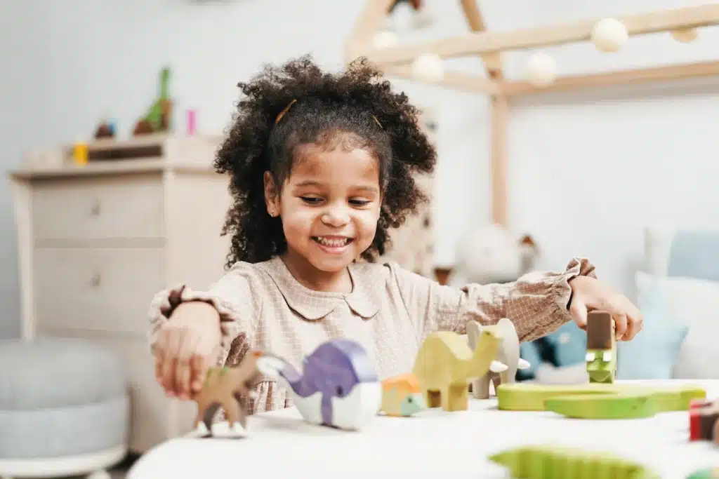 Smiling child playing with wooden toys
